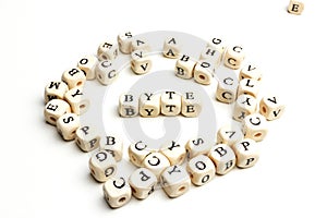 letter cubes lying on white table. Byte