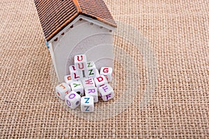 Letter cubes and model house on a canvas