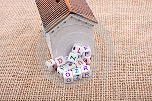 Letter cubes and model house on a canvas