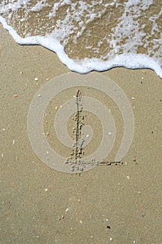 Letter drawn on the sand beach