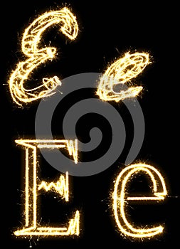 Letter E. Alphabet made by sparkler. Isolated on a black background.