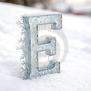 Letter E with ice elements isolated on white background
