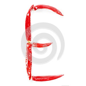 Letter E made from red hot chili peppers. Isolated on white background