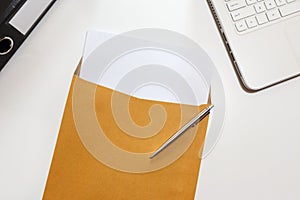 Letter in envelope with file and notebook on desk - business con