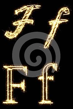 Letter F. Alphabet made by sparkler. Isolated on a black background.