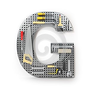 Letter G. Alphabet from the tools on the metal pegboard isolated photo