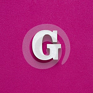 Letter G uppercase - White wood font on rhodamine red background