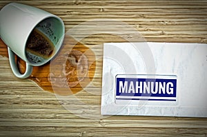 Letter with in german Rechnung in english bill and a dumped coffee cup from fright