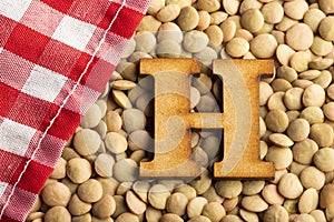 Letter H, Lentils with checkered napkin - Top view