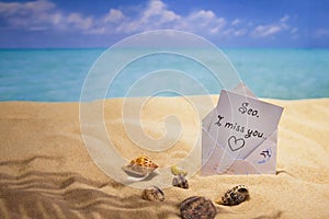 Letter `I miss the sea`, sea coast, hot sand