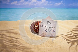 Letter `I miss the sea`, sea coast, hot sand