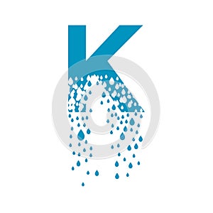 The letter K dissolves into droplets. Drops of liquid fall out as precipitation. Destruction effect. Dispersion