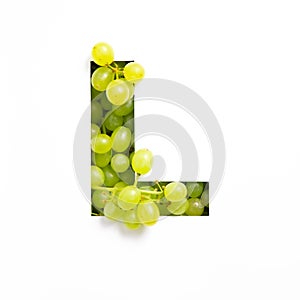 Letter L of English alphabet of green grape and cut paper isolated on white. Appetizing typeface made of fresh berries