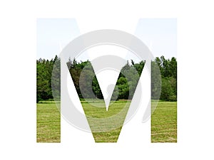 Letter M of the alphabet made with landscape with grass, forest and a blue sky