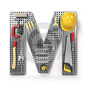 Letter M. Alphabet from the tools on the metal pegboard isolated photo