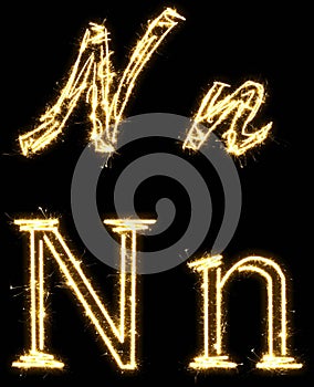 Letter N. Alphabet made by sparkler. Isolated on a black background.