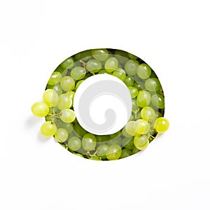 Letter O of English alphabet of fresh grape and cut paper isolated on white. Typeface of green berries