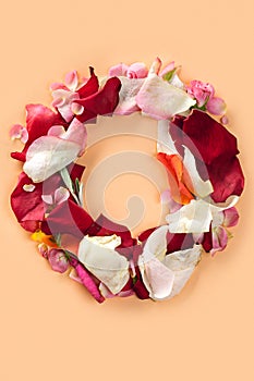 Letter O made from red roses and petals isolated on a white background