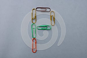 Letter P made with colorful paper clips on white background