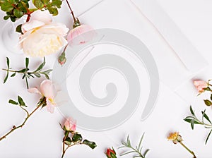 Letter, pen and white envelope on white background with pink english rose. Invitation cards or love letter. Birthday