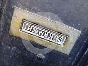 Old brass letter plate on a door