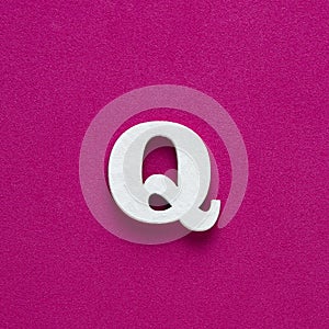 Letter Q uppercase - White wood font on rhodamine red background