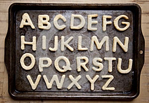 Letter shaped cookies on baking tray