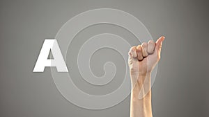 Letter A in sign language, hand on background, communication for deaf, lesson