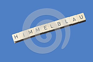 Letter tiles on blue Background showing the word Himmelblau