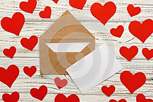 Letter to Valentine Day. Love letter envelope with red hearts on wooden background