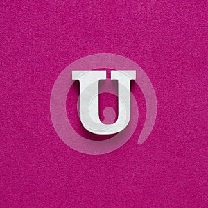 Letter U uppercase - White wood font on rhodamine red background