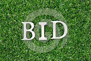 Letter in word bid on green grass background