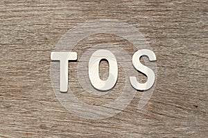 Letter in word TOS abbreviation of Terms of service on wood background