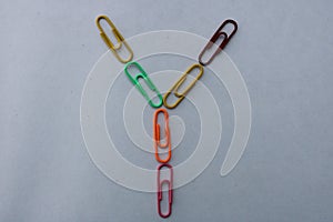 Letter Y made with colorful paper clips on white background