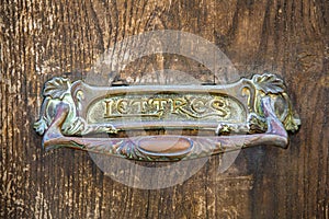 Letterbox detail in an ancient wooden door