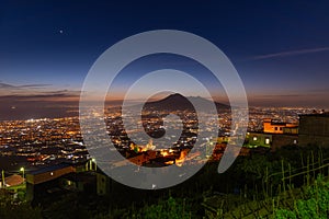 Lettere, Italy. May 12th, 2020. Panoramic view of Mount Vesuvius seen from the village of Lettere after sunset with night lights photo