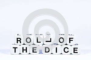 Lettered dice spelling out the phrase roll of the dice