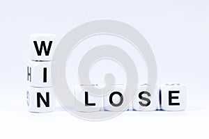 Lettered dice spelling out the words win and lose