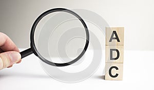 Lettering ADC on wooden cubes on a gray background photo