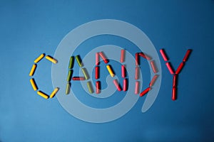 Lettering CANDY made of gumdrops  on blue background