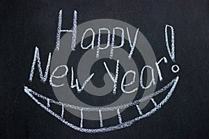 Lettering on chalkboard Happy New Year and drawn smile