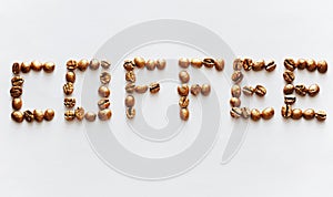 Lettering Coffee made of golden pearl coffee beans on white background. Expensive coffee concept