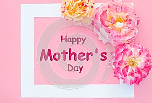 Lettering Happy Mother`s Day with delicate multi-colored roses on a pink background