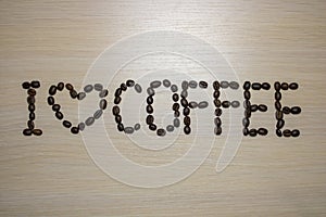 Lettering I love coffee on a light wood background.