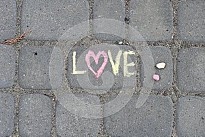 Lettering LOVE made iwith chalk on the road