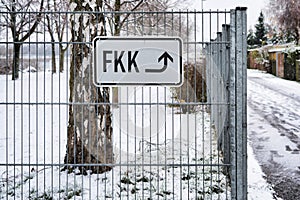 Lettering `nudist beach` on the fence at a bathing lake in Germany