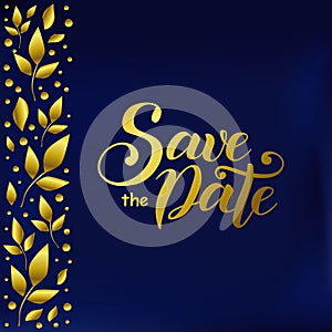 Lettering of Save the date in golden gradient on blue velvet background decorated with golden leaves at the left side