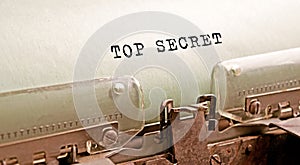 Lettering TOP SECRET. Corner text typed on paper with an antique typewriter. Vintage lettering, retro style, grunge, business or
