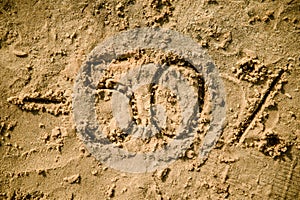 50 lettering written on sand