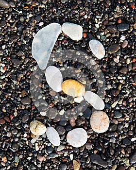 Letters alphabet laid on a black sand. S.